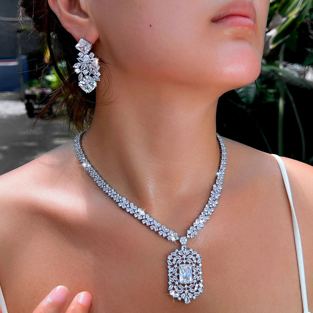 Cubic zirconia flower necklace and earrings set with clear stones in an ornate halo design
