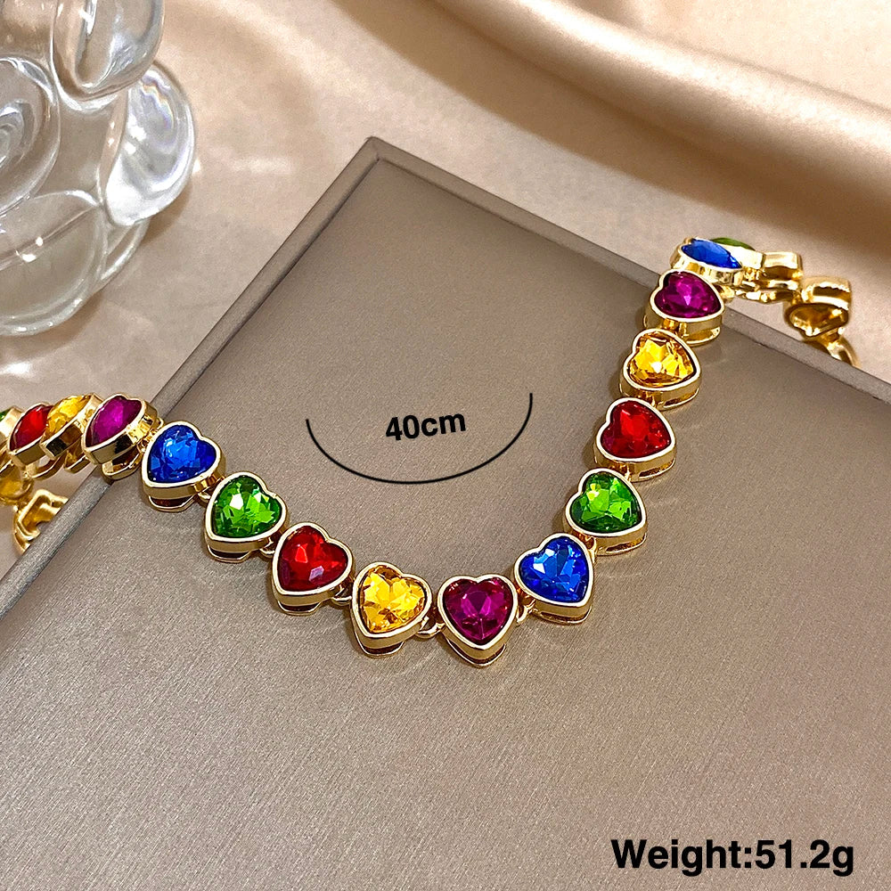 Gold-tone heart zircon link chain choker with multicolor heart stones on jewelry card
