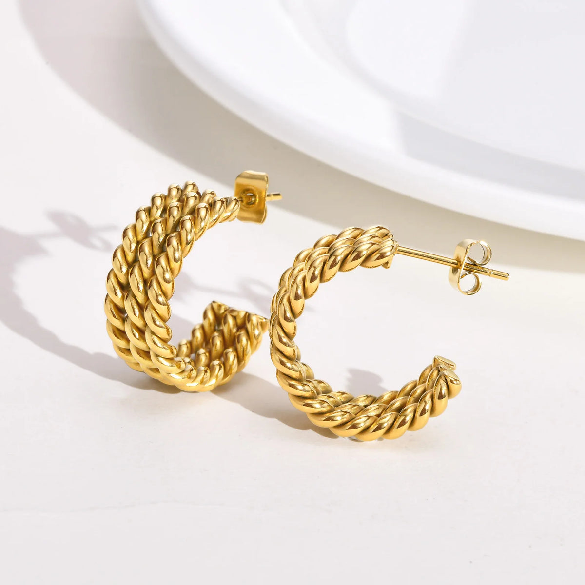 Pair of gold-tone rope-twist open hoop earrings, shown with butterfly backs
