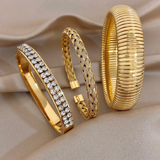Gold-tone ribbed cuff bangle with zircon stone pave stripe and braided bracelet
