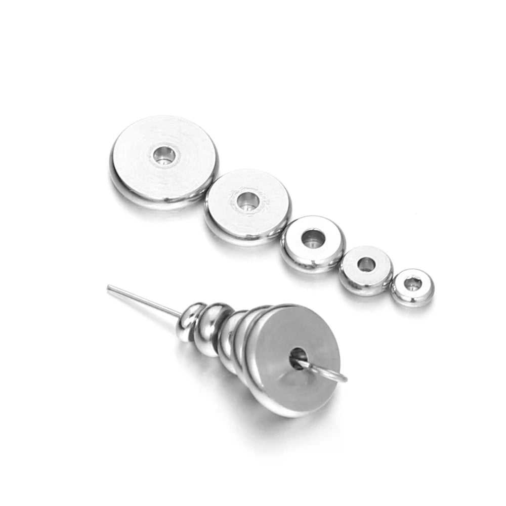 Steel round flat spacer beads and a few small beads, each with a center hole