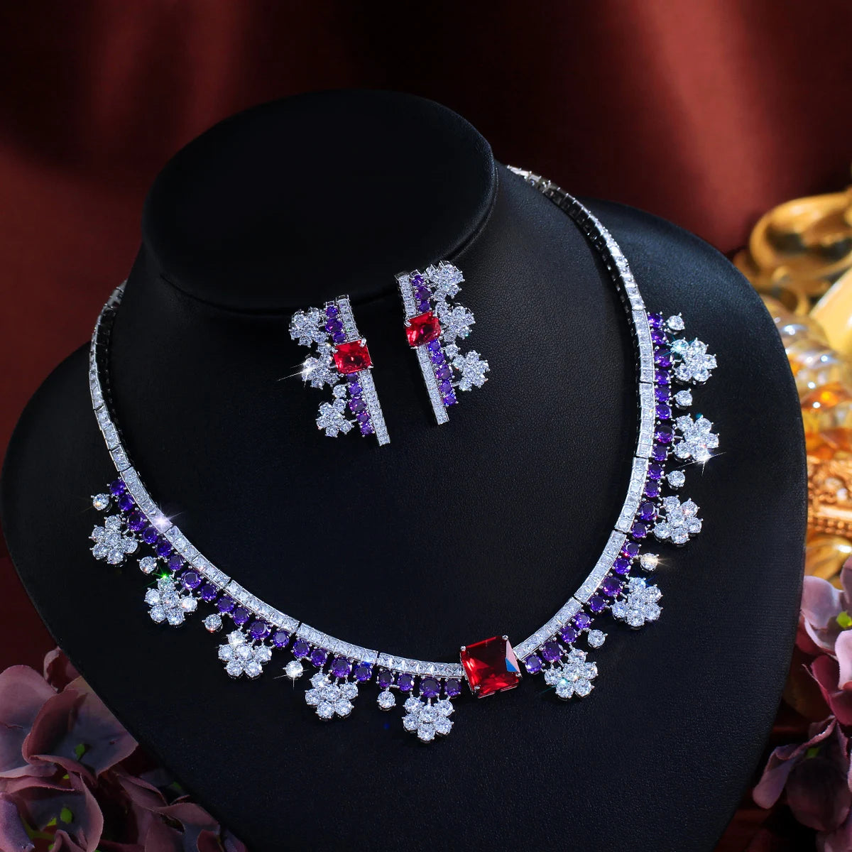 Multicolor crystal choker necklace and matching earrings set on display bust