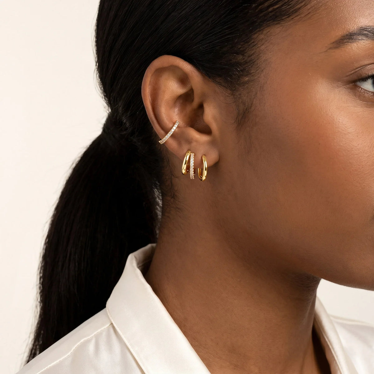 Gold-plated CZ huggie hoop earrings, small stacked hoops on one ear