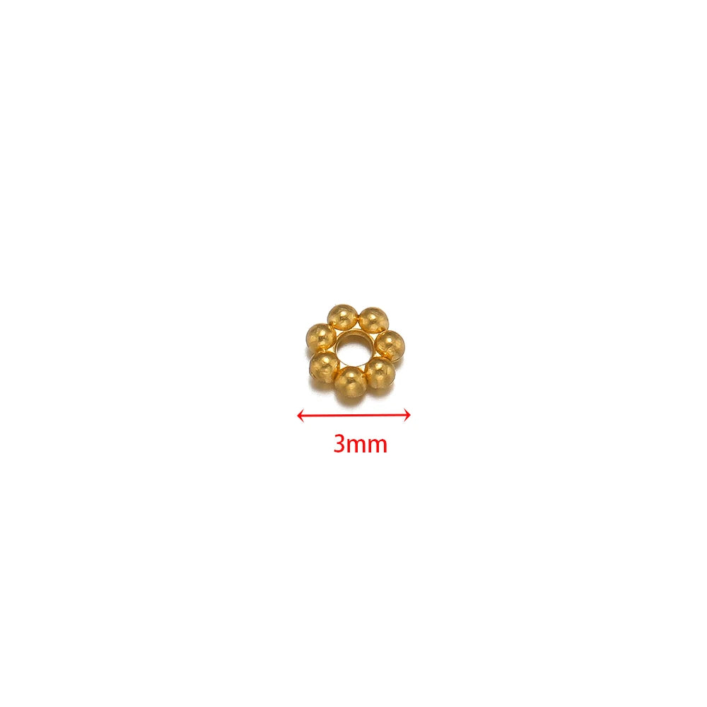 Gold flower spacer bead, single piece shown with 3mm size marker.
