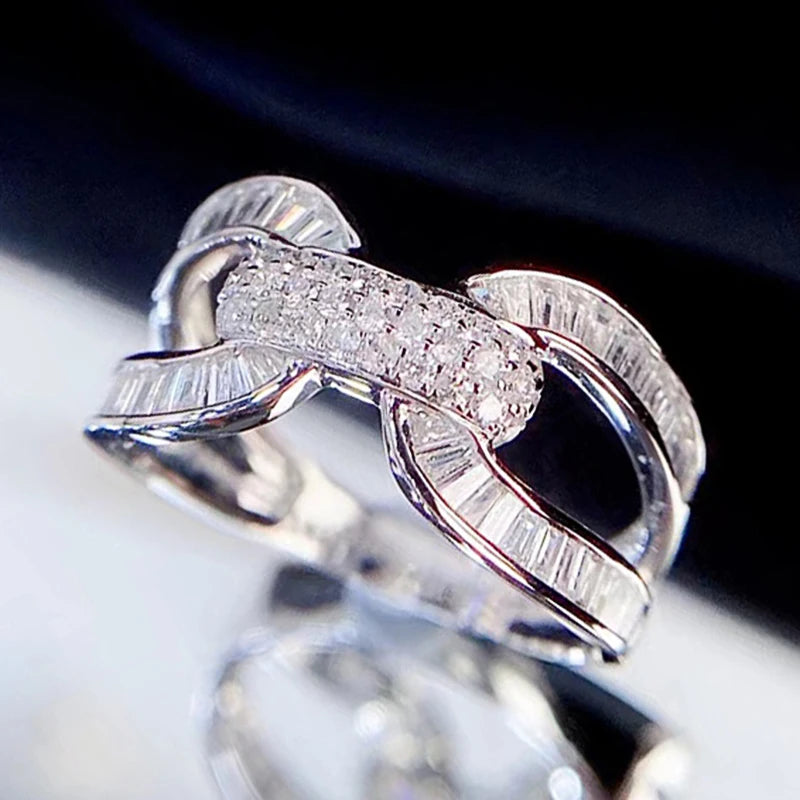 Silver wedding ring with interlocking band design and pavé stones