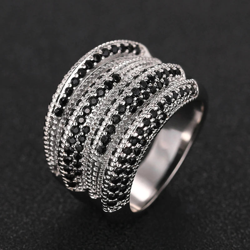 Multi-row silver-tone ring with raised arcs of black and clear stones