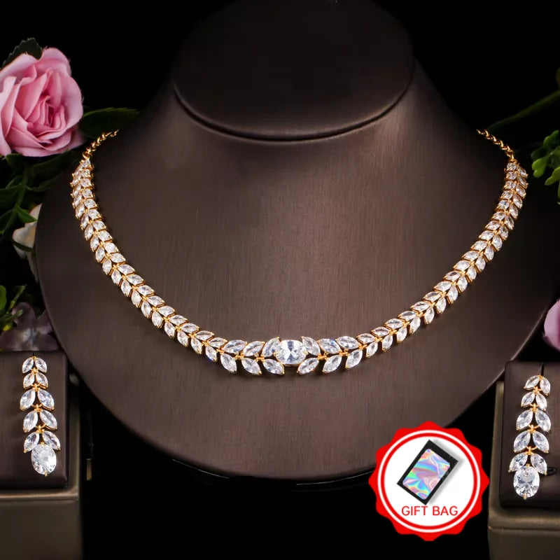 Gold-tone necklace and drop earrings with leaf-shaped cubic zirconia stones