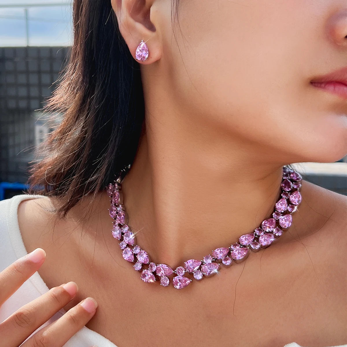 Pink crystal teardrop necklace with matching drop earrings, model wearing the set