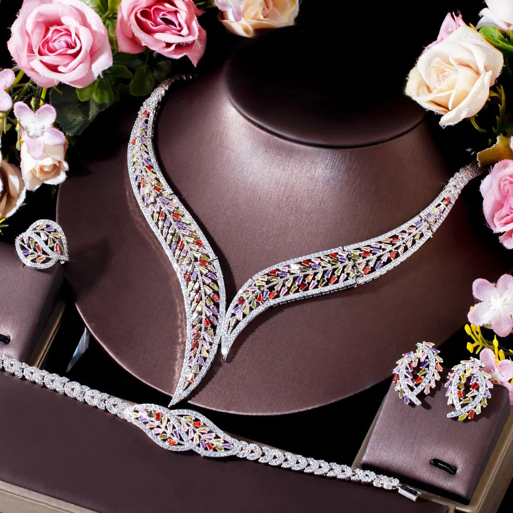 Multicolor cubic zirconia leaf bridal set on display: necklace, bracelet, earrings, ring