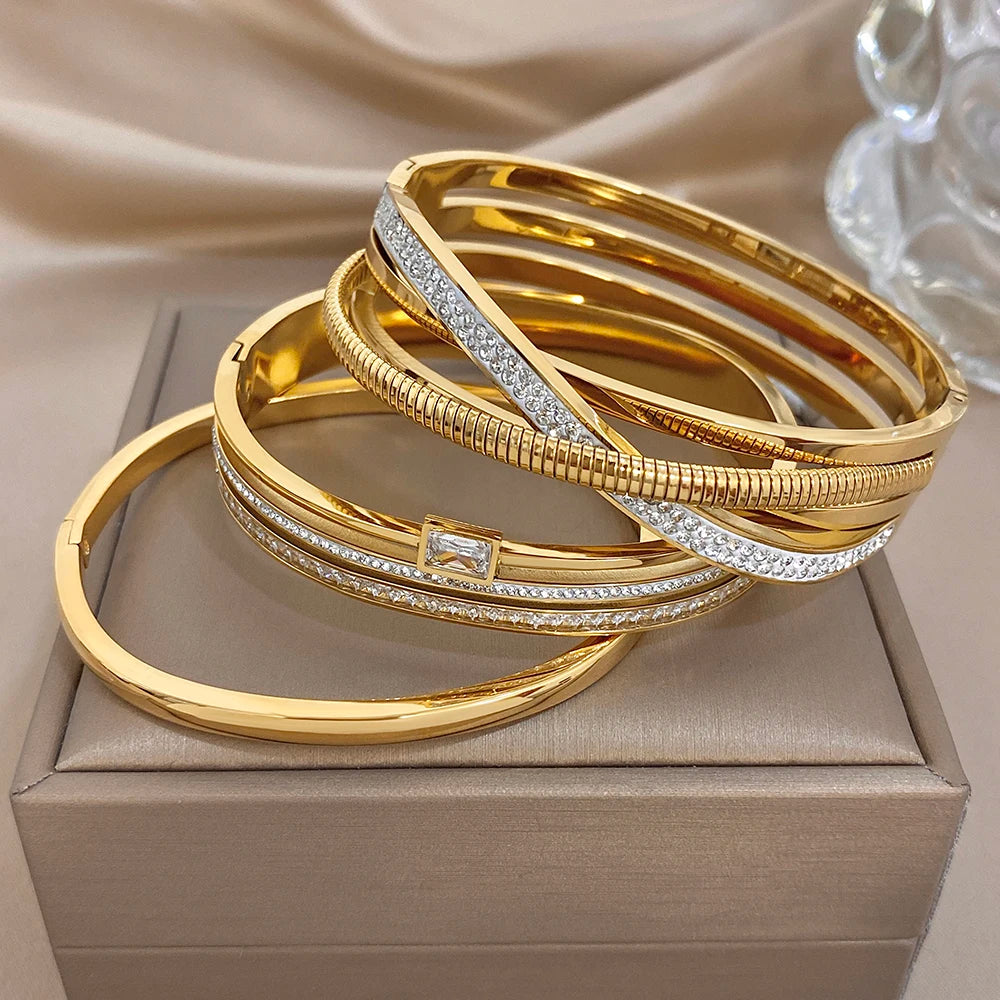 Gold-plated stainless steel cuff bangles with zircon accents, stacked together