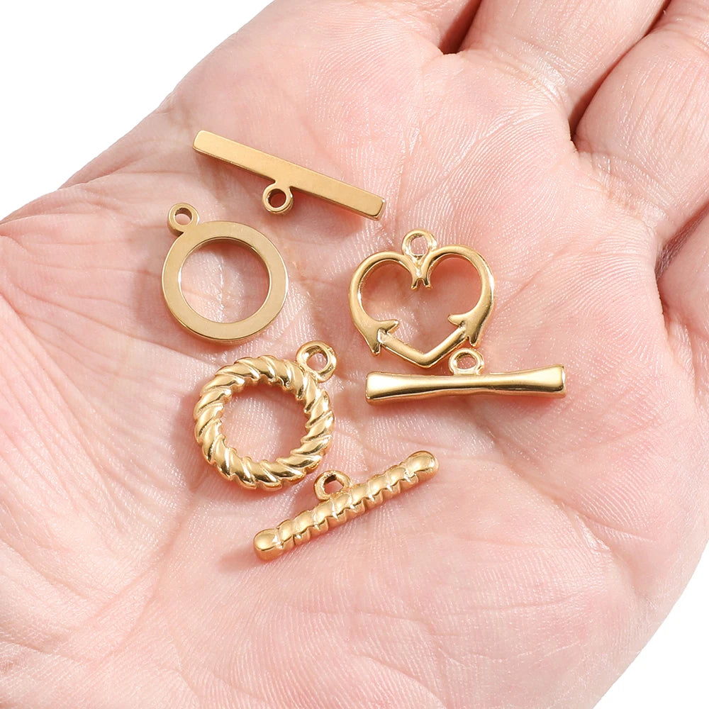 Gold toggle clasp set with heart connector, bar fastener, and braided ring loops