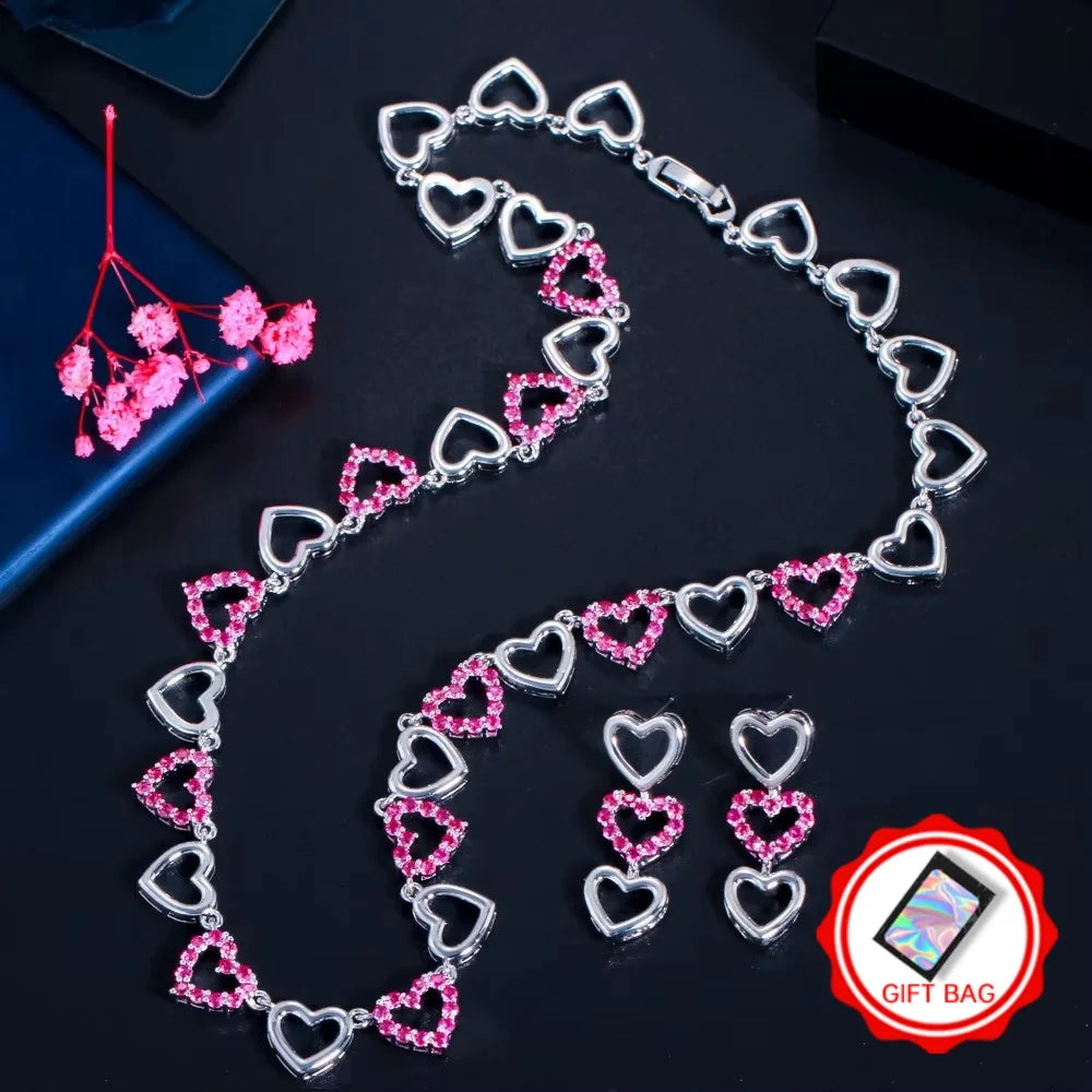 Silver-tone heart necklace and matching earrings with pink rhinestone accents