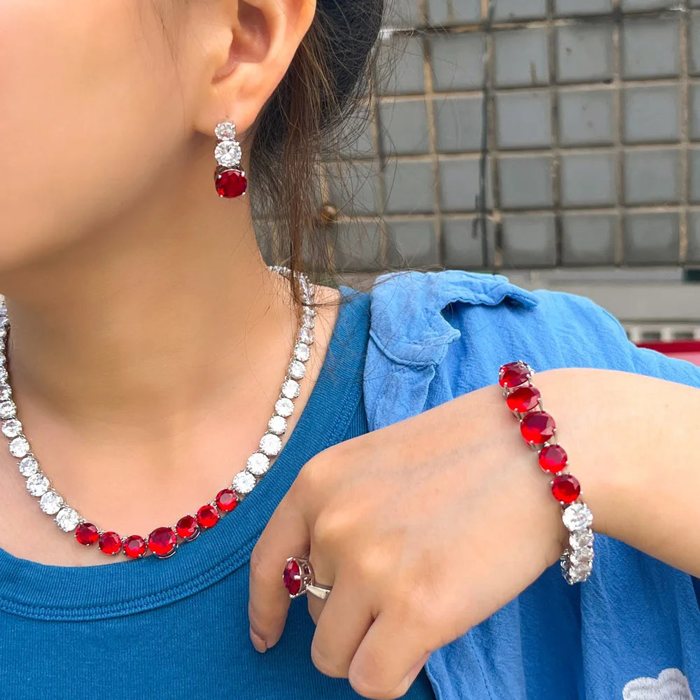 Red cubic zirconia tennis jewelry set: necklace, bracelet, ring, and earrings