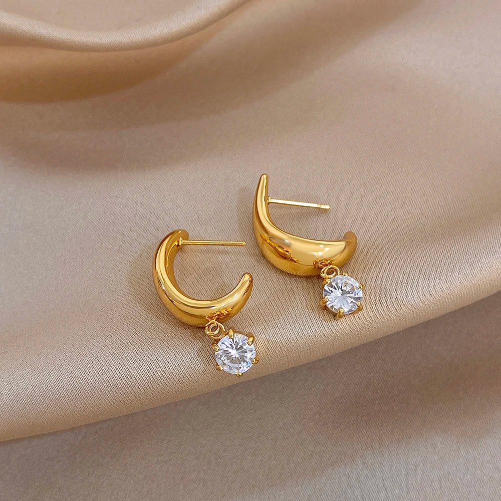 Gold-tone hoop earrings with clear round crystal drops on hooks