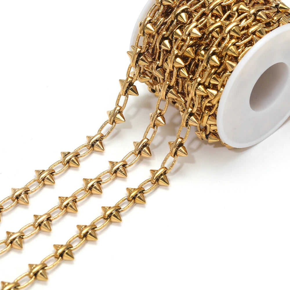 Gold bow knot chain links on a white spool for DIY jewelry making