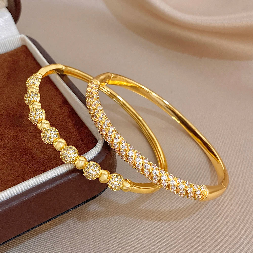 Gold-plated copper cuff bangles with zircon beads and twisted pave detail