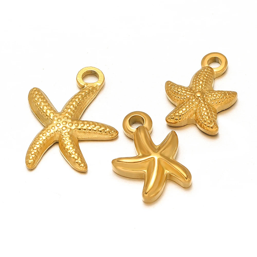Gold starfish charm pendants with loop bails, three-piece close-up