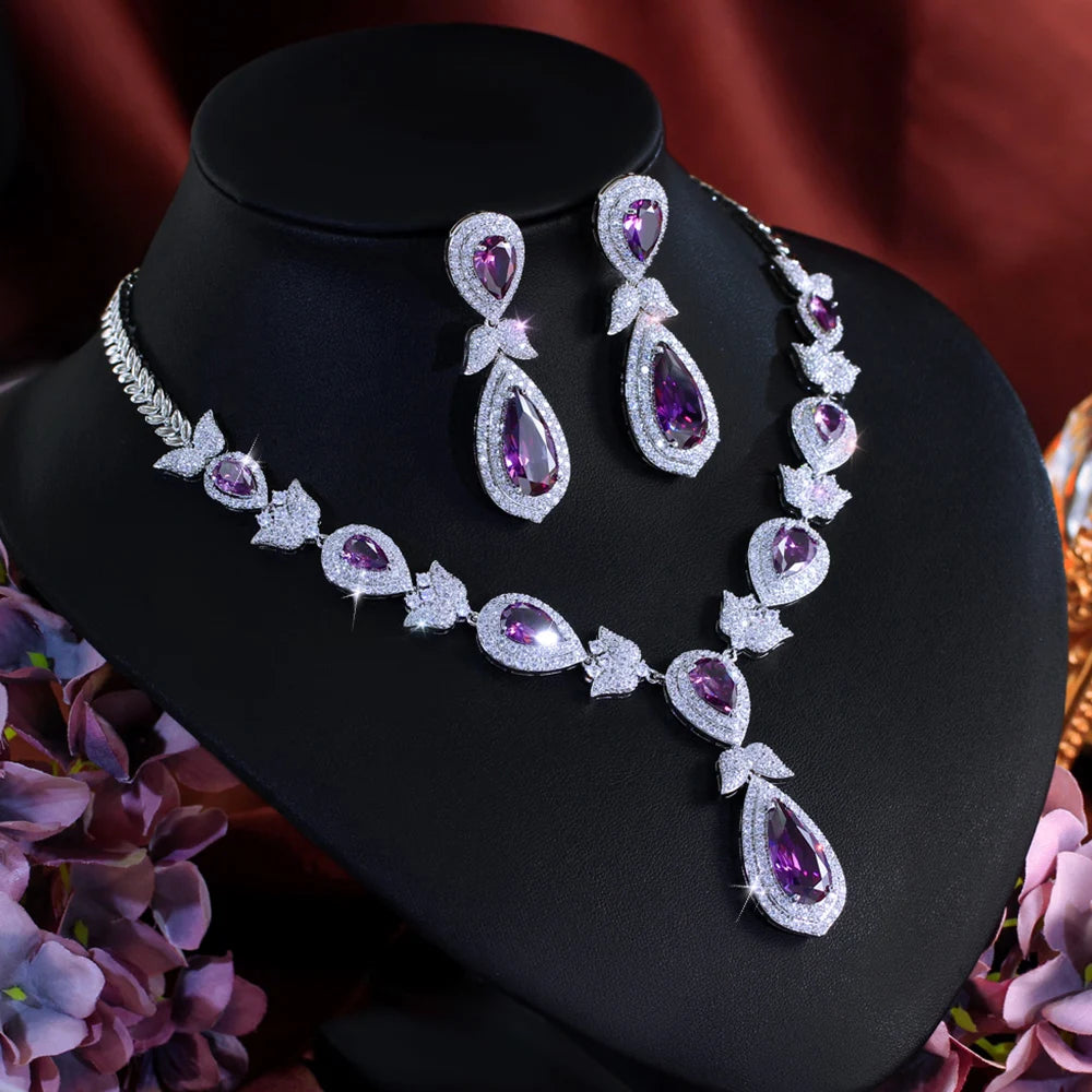 Angled view of purple teardrop crystal necklace and matching drop earrings