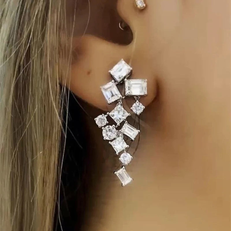 Long silver-tone cubic zircon dangle earrings with alternating square and round stones