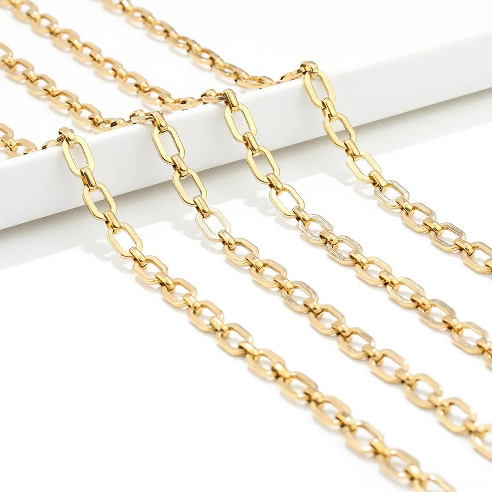 Gold square link chain laid out straight, showing repeating connected link pattern