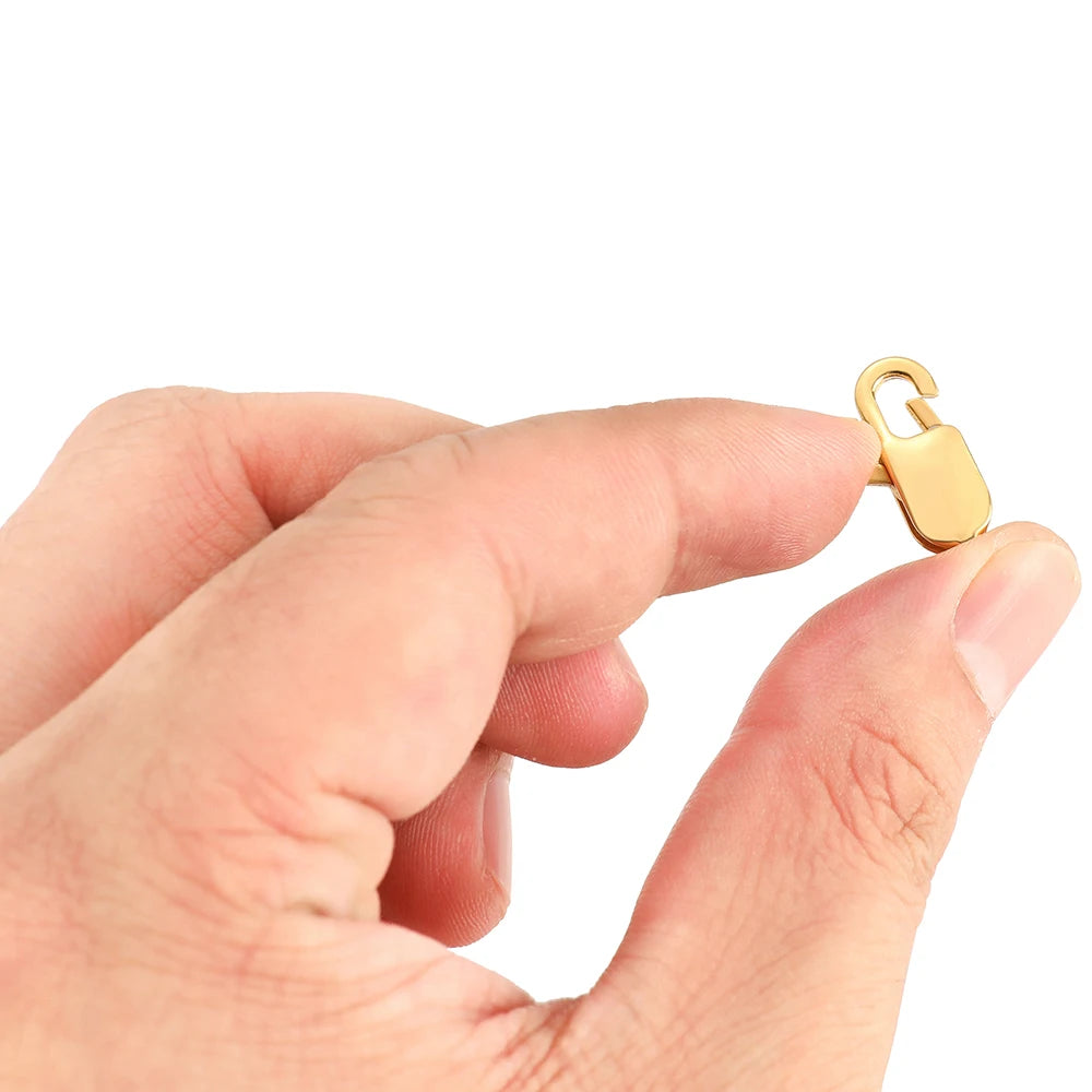 Gold rectangle lobster clasp held in hand, spring gate connector for jewelry