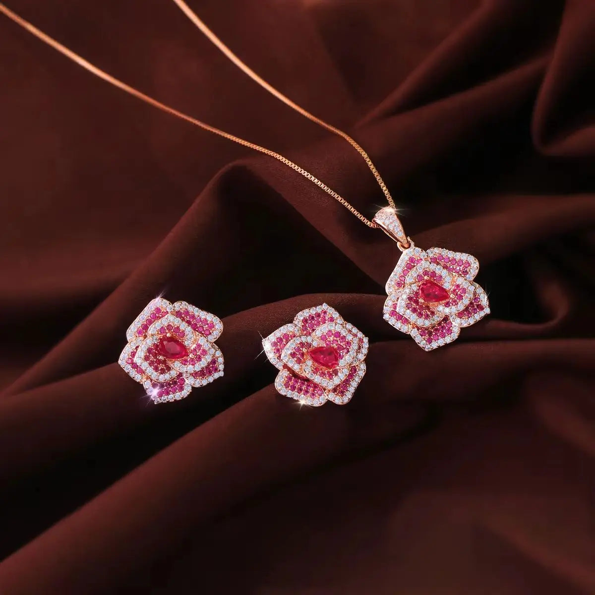 Rose-red flower CZ pendant necklace and matching earrings displayed together