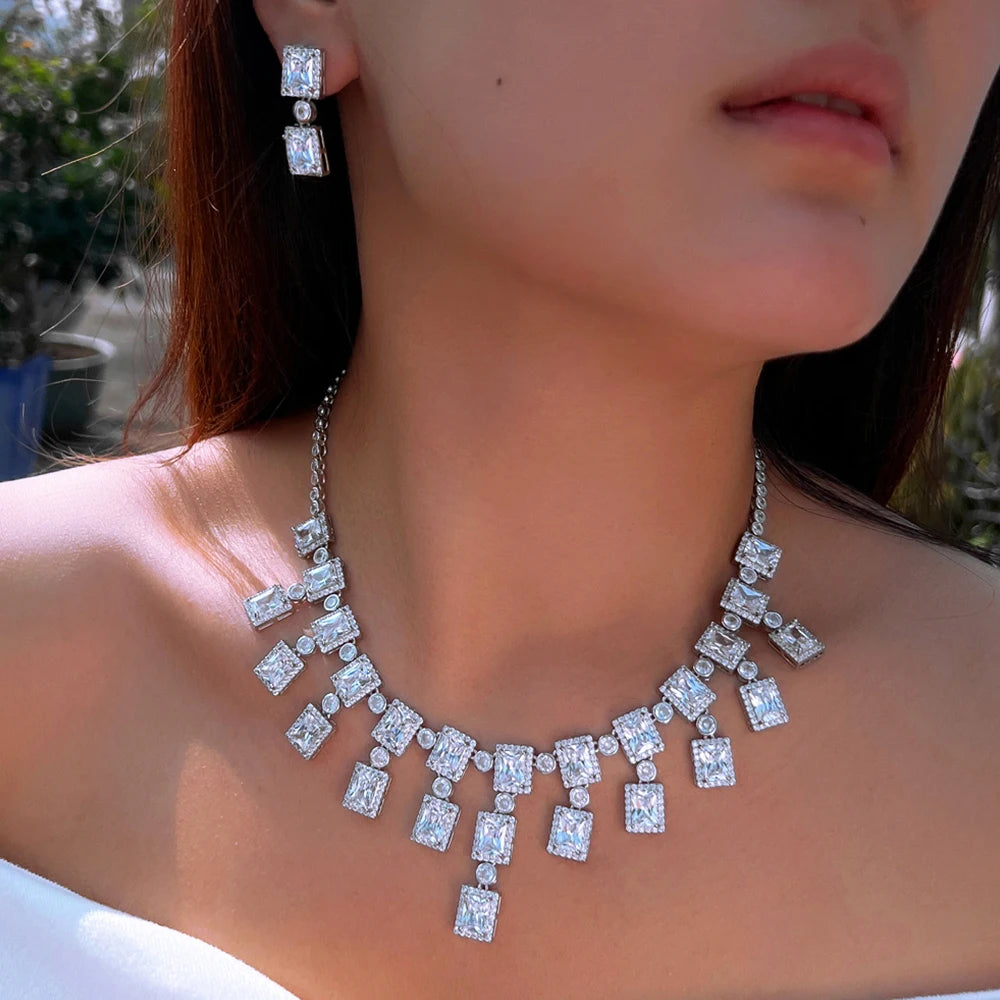 CZ square crystal necklace and dangling drop tassel earrings on model