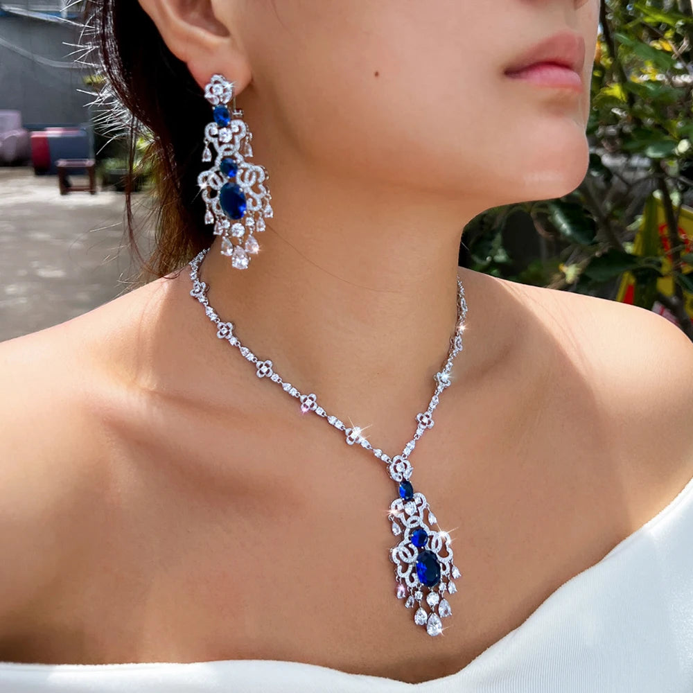 Silver-tone necklace and earrings set with royal blue teardrop crystal accents