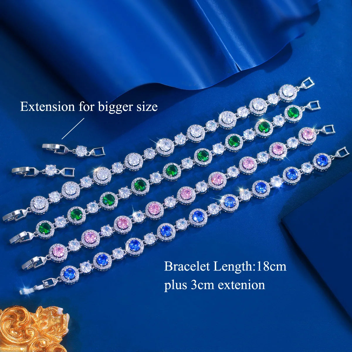 Five silver-tone tennis bracelets with round clear, green, pink, and blue stones and an extender