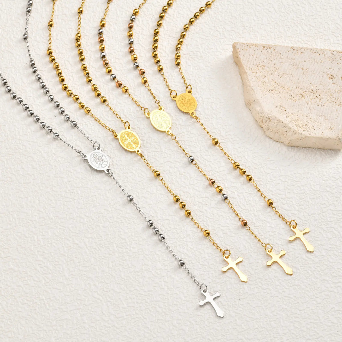 Rosary necklace set with gold and silver chains, round medallions, and cross charms