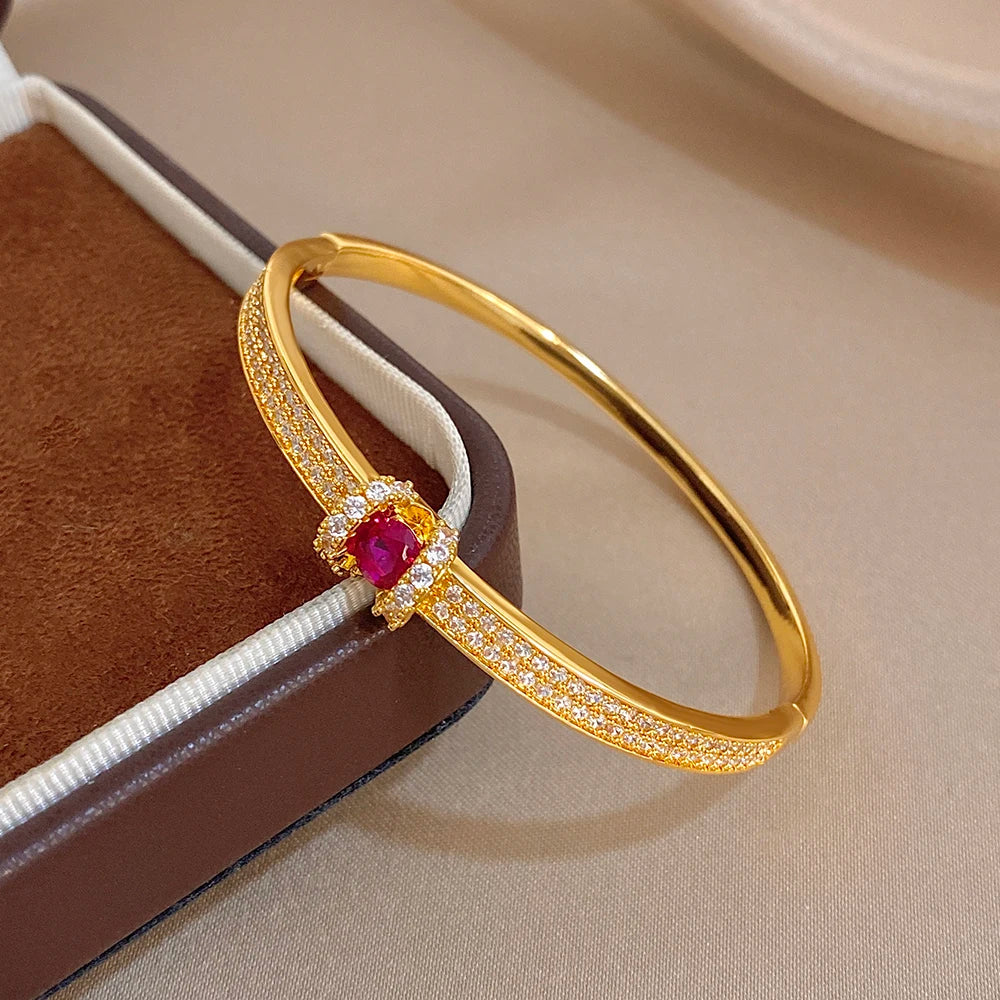 Gold zircon cuff bangle with pink round center stone and slim crystal pave band