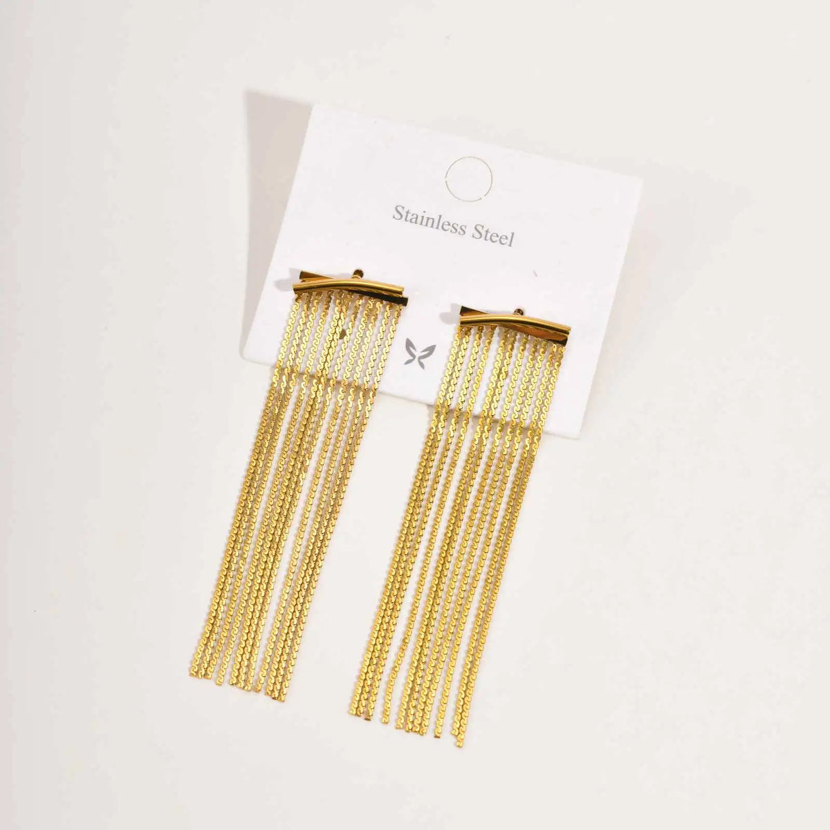 Gold chain fringe tassel earrings on a card labeled Stainless Steel