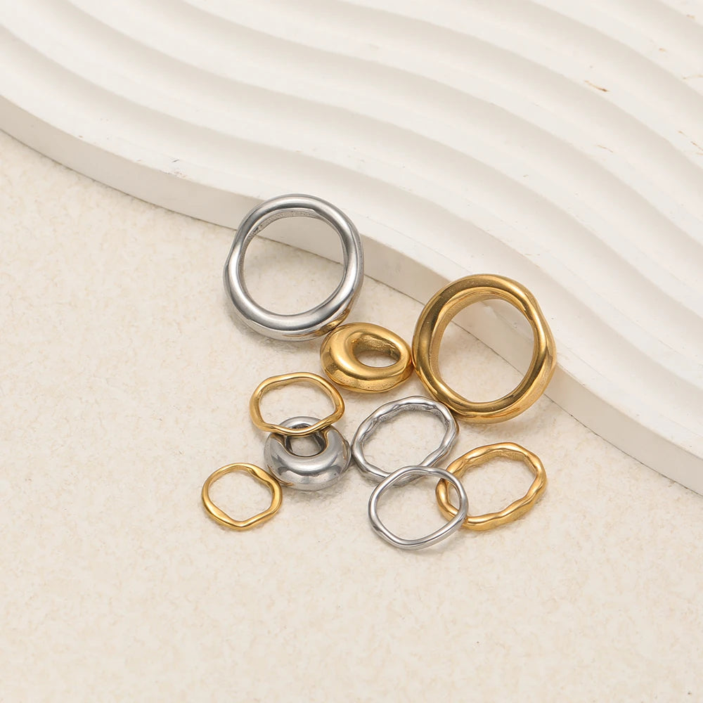 Set of five silver and gold-tone open ring charms and small bead connectors