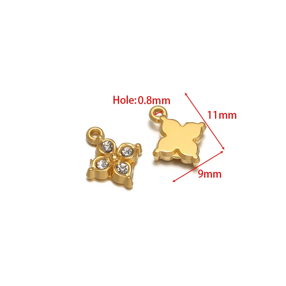 Gold-tone charm pendants with rhinestones and hanging loops, with small round hole