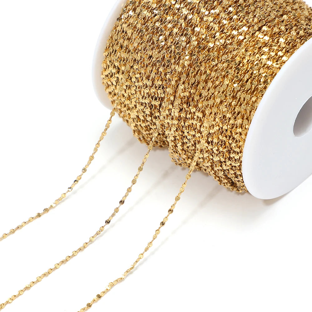 Gold plated flat flower chain on white spool, delicate linked chain for jewelry making