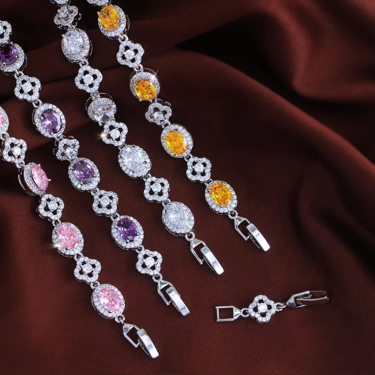 Pink, purple, clear, and yellow oval crystal flower tennis bracelets with clasps