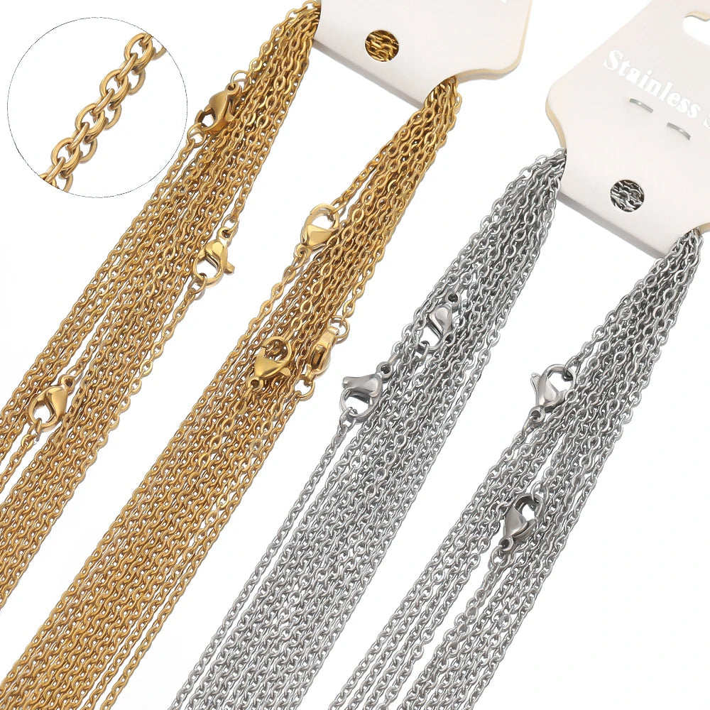 Gold and steel cable link chains on a card, showing clasp connector ends