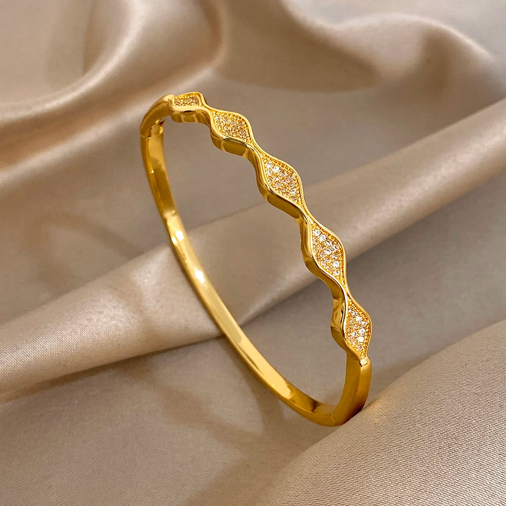 Gold-plated geometric wave cuff bangle bracelet with sparkling stone inlays