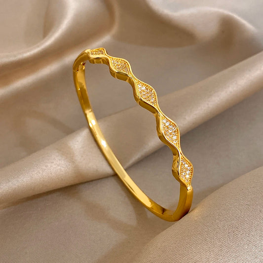 Gold-plated geometric wave cuff bangle bracelet with sparkling stone inlays