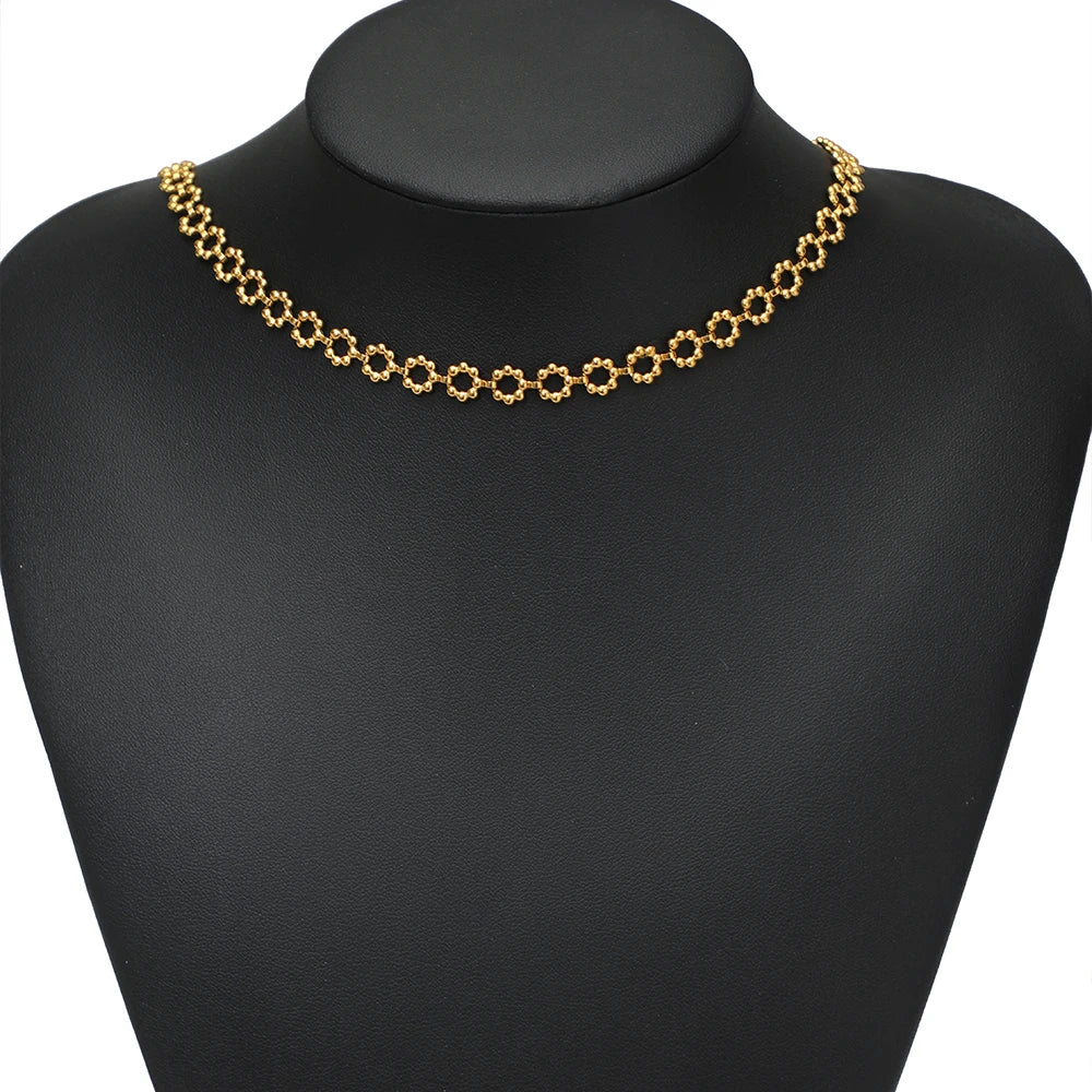 Gold square-link necklace chain on black mannequin bust, short choker length