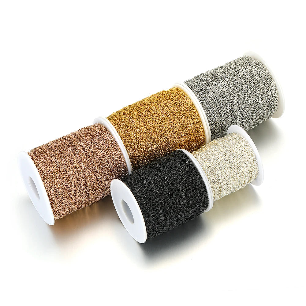 Stainless steel chain links on four spools in brown, gray, black, and light silver