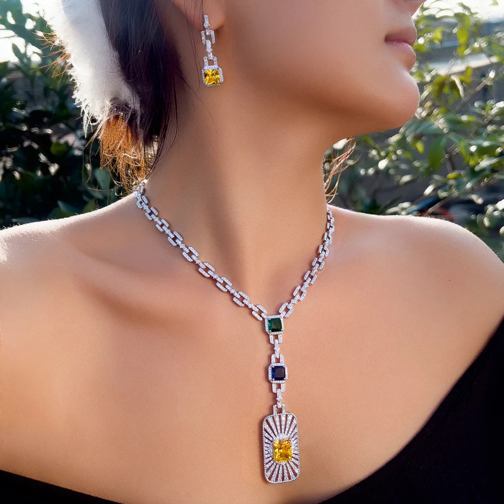 Zirconia cuban link necklace set on model with green square charm and heart-shaped pendant