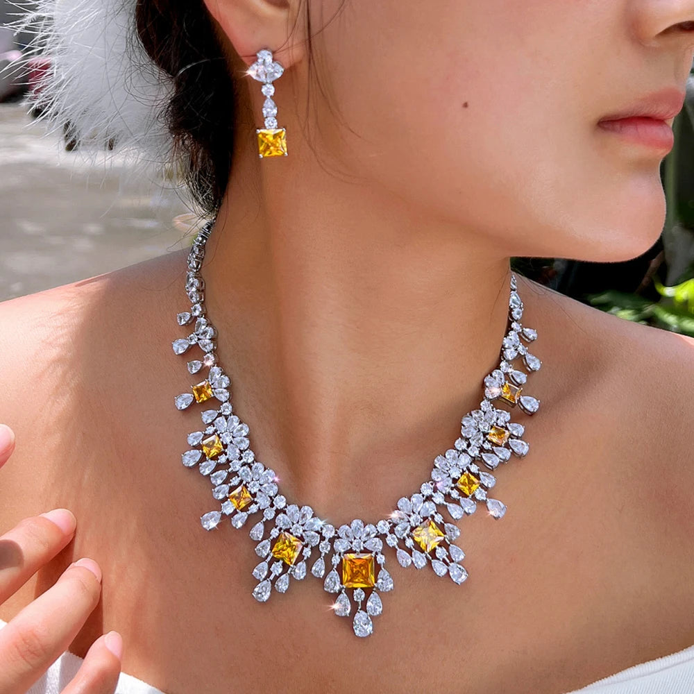 Cubic zirconia necklace and drop earrings with yellow accents, silver-tone sparkle.