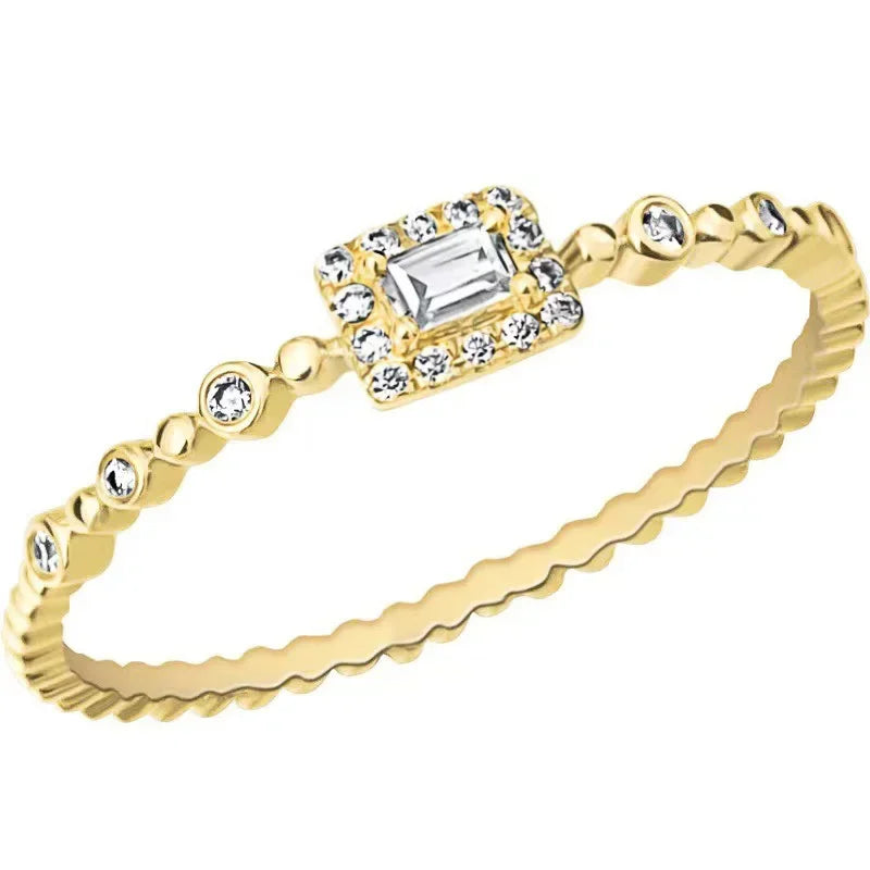 Gold-tone delicate ring with square center stone and halo, plus beaded band