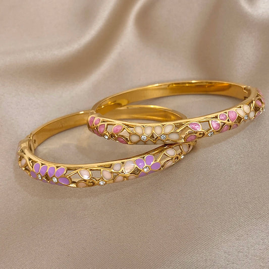 Gold-plated cuff bangle set with purple enamel flower inlays and crystal accents