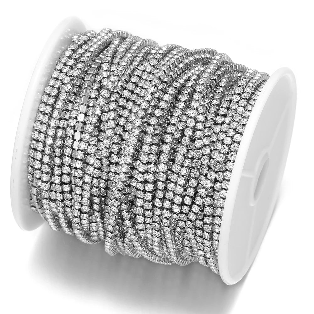 Silver-toned cubic zircon chain roll on white spool, multiple tight coils