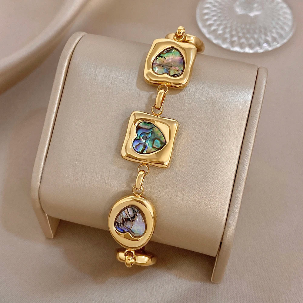 Gold-tone abalone-shell charm bracelet with stacked heart and square link charms