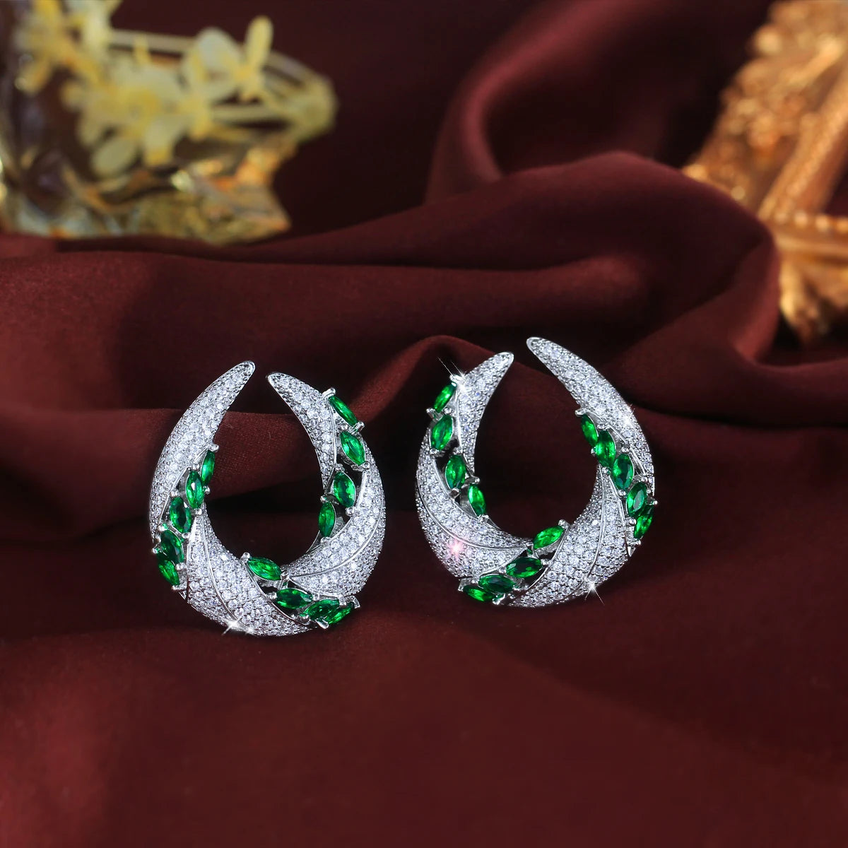 Geometry cubic zirconia crescent drop earrings with green and white stones