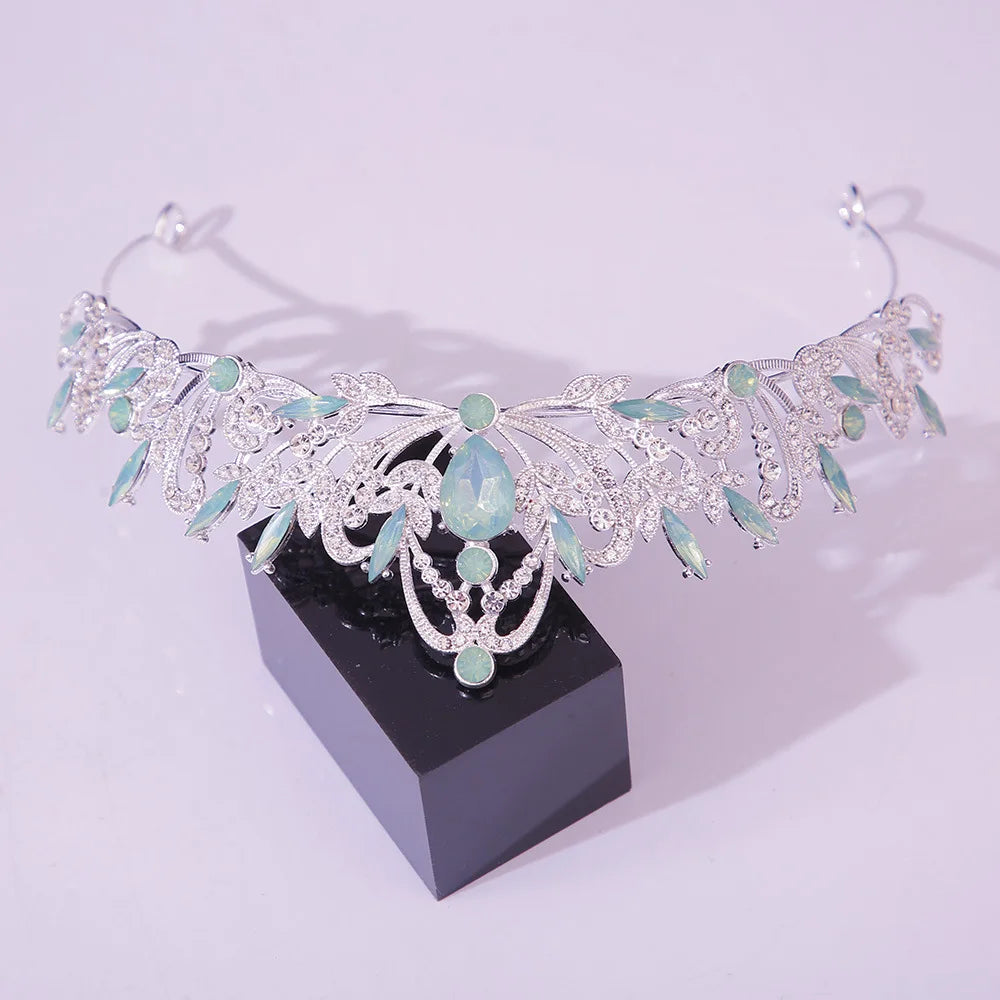 Jeweled bridal tiara crown with light green and clear oval gemstones, silver-toned vines
