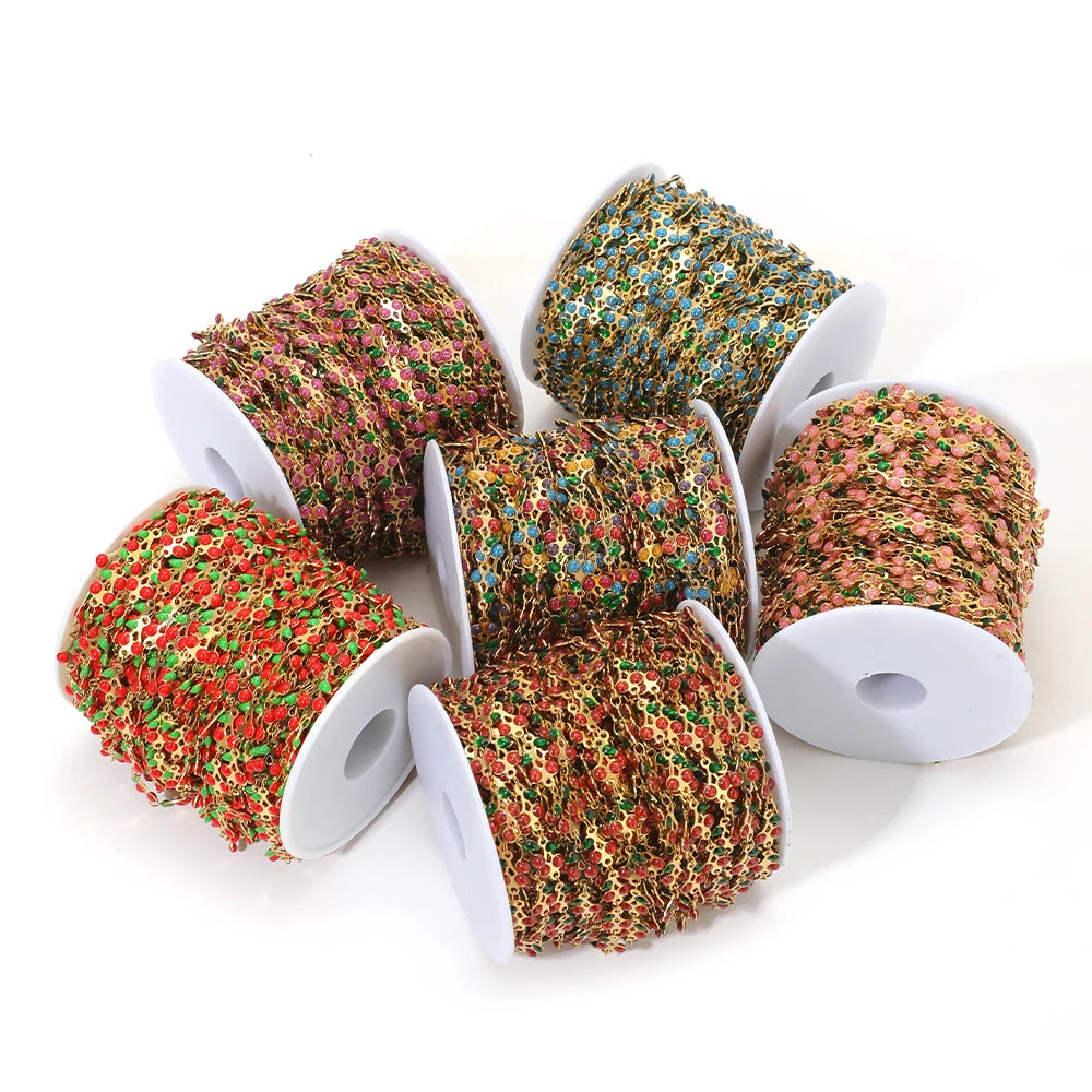 Mixed-color cherry charm chain spools for DIY kids jewelry making on white reels